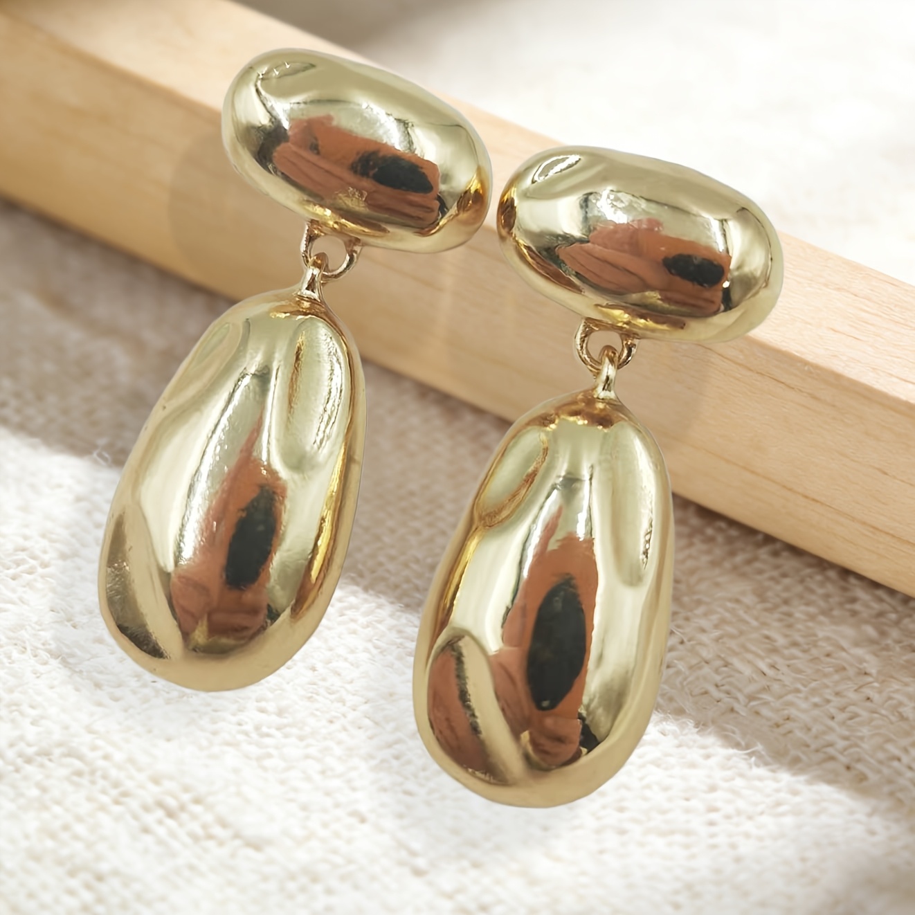 Metal Earrings with Golden Glossy Finish and Teardrop Pendant